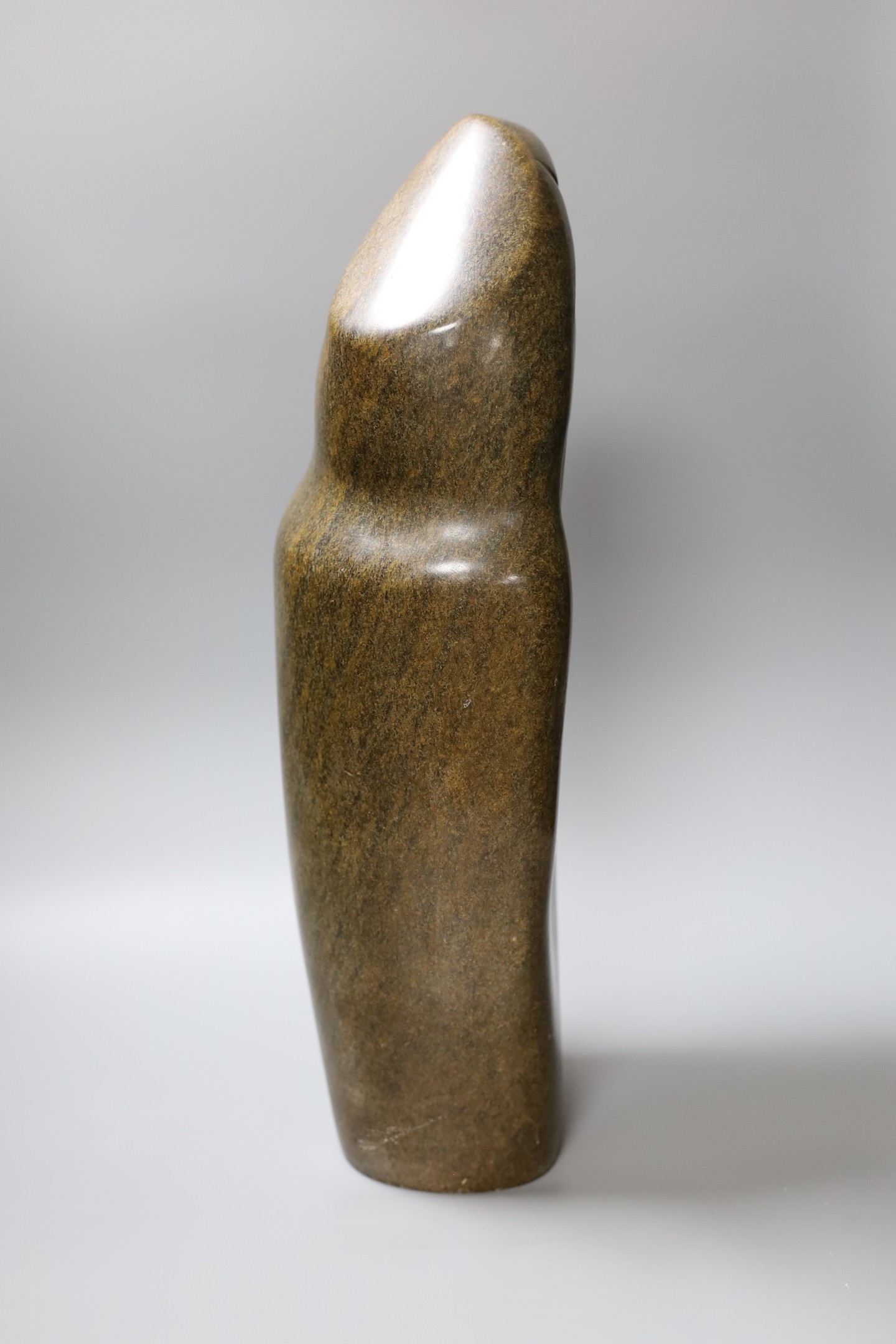 A Zimbabwean carved and polished stone slender abstract figure, 48cm tall